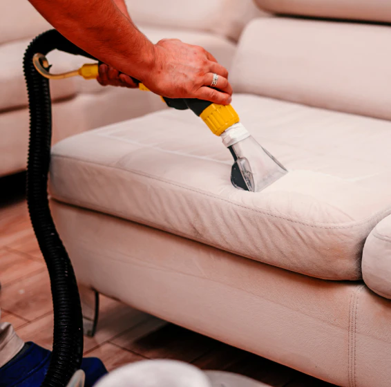 worker doing an upholstery cleaning